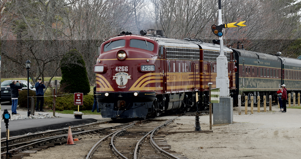 Maroon and Gold F unit locomotives on passenger train