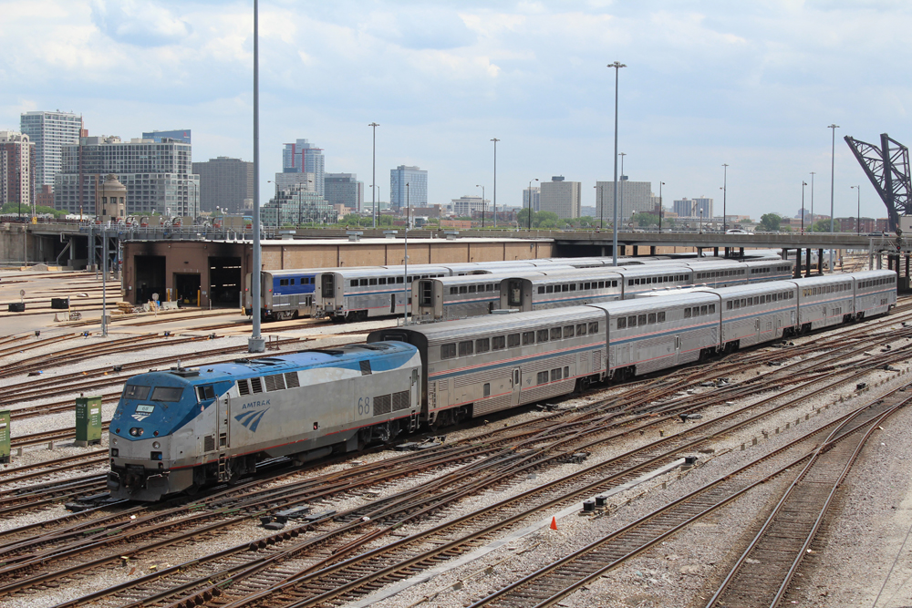 Passenger train passing Amtrak coach yard