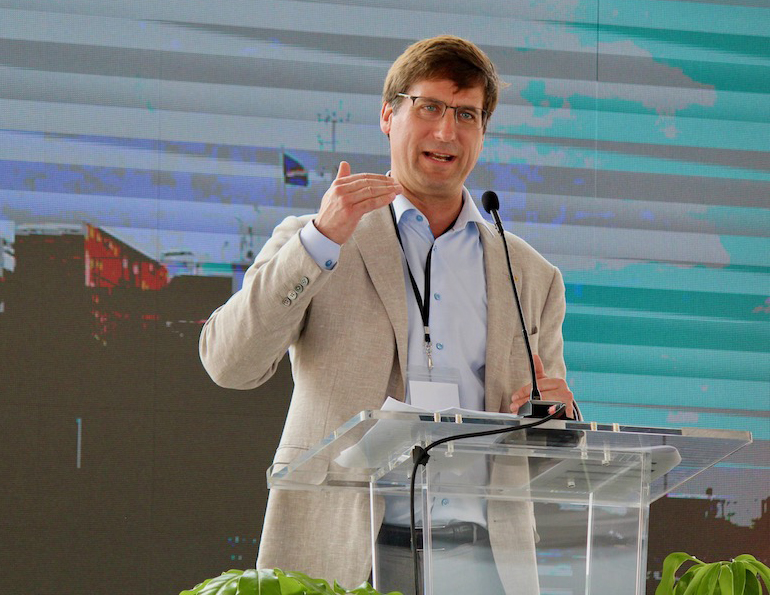 Man gesturing while speaking at podium