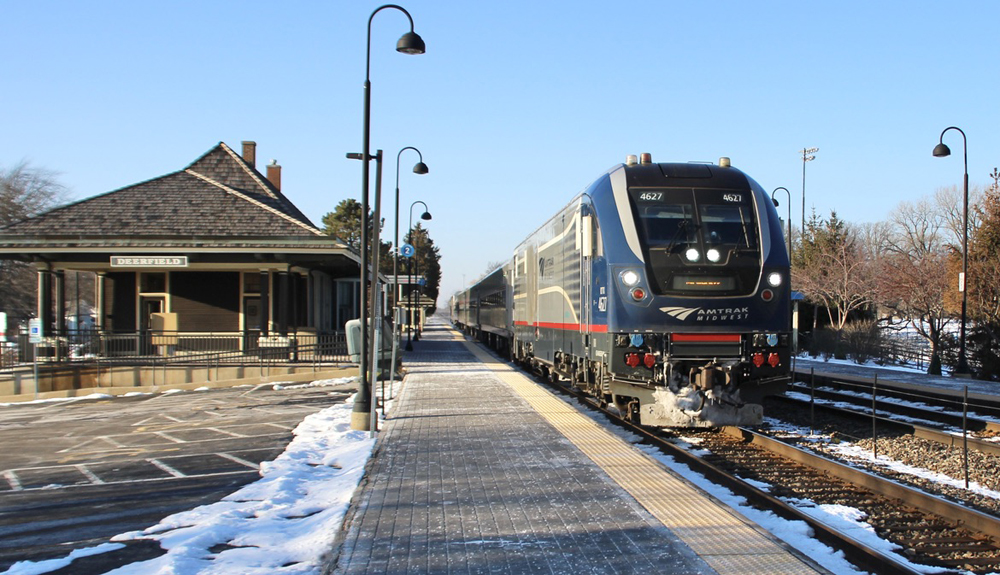 Passenger train passing station