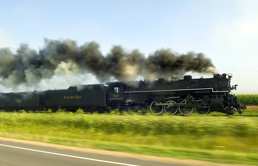 Steam engine operating in farmland