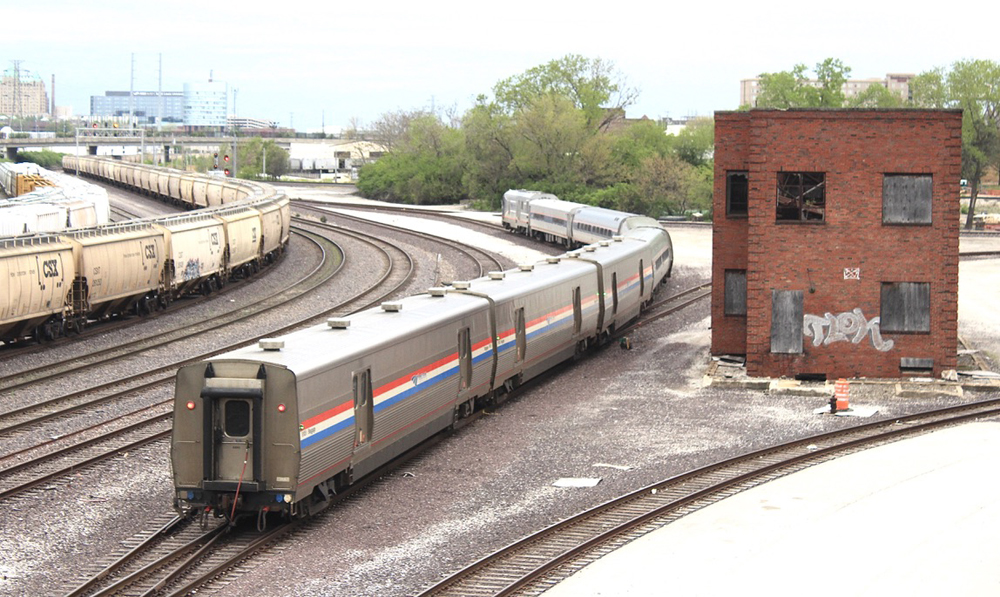 Passenger train with several baggage cars at the curve of the rear towers