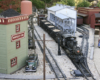 Model steam locomotive in garden railway scene