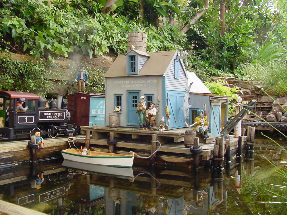 House, wharf, and steam locomotive in scene