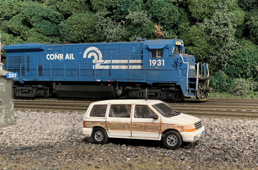 picture of a model blue locomotive and model minivan