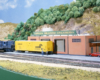 Photo of four-axle road unit switching cars on HO scale layout.