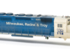 Photo of HO scale locomotive body shell painted blue and white on white background.
