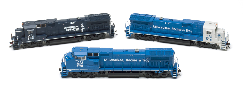 Photo of three HO scale diesel locomotives in various paint schemes on white background