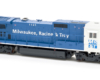 Photo of blue and white HO scale locomotive on white background