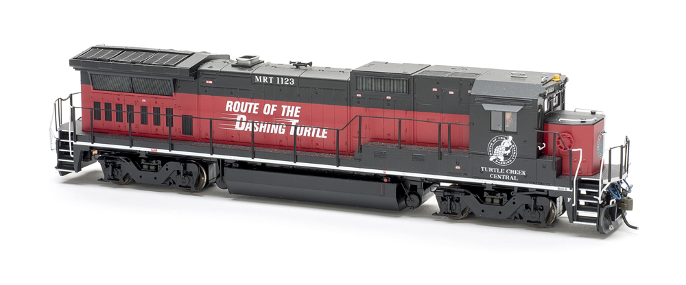 Photo of red and black HO scale locomotive on white background