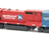 Photo of red and blue wide-cab HO scale locomotive on white background