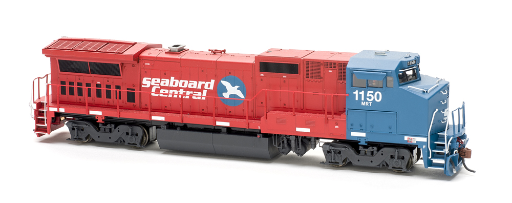 Photo of red and blue wide-cab HO scale locomotive on white background