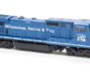 Photo of blue and white wide-cab HO scale locomotive on white background