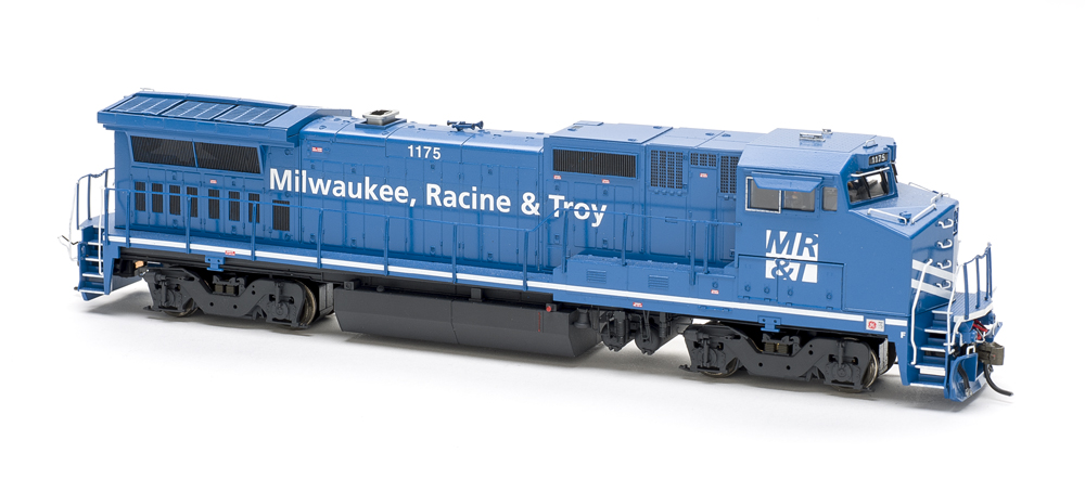 Photo of blue and white wide-cab HO scale locomotive on white background