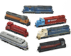 Photo of seven HO scale diesel locomotives on white background.