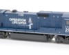 Photo of dark blue four-axle GE road unit on white background