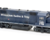 Photo of painted and weathered dark blue road locomotive on white background