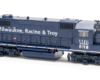 Photo of dark blue four-axle road locomotive in fresh paint on white background