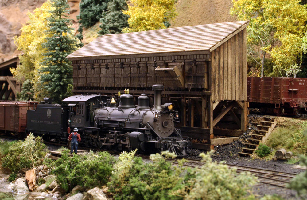 Black steam engine in a rural scene.