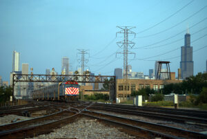 Passenger train in a city landscape approaching the photographer at speed.