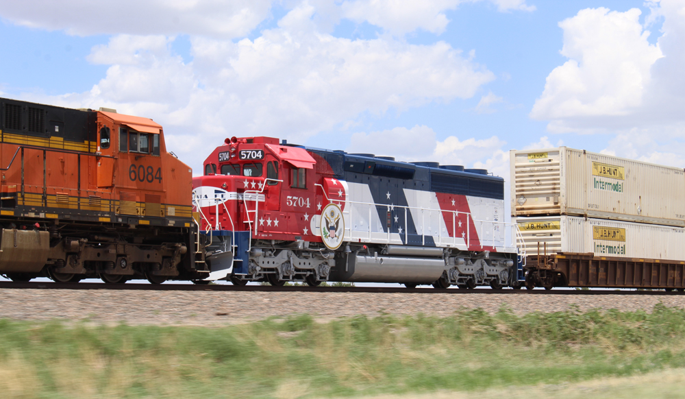 Red, white, and blue locomotive on intermodal train