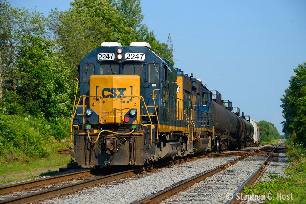 Blue and yello locomotives with short string of freight cars on straight track
