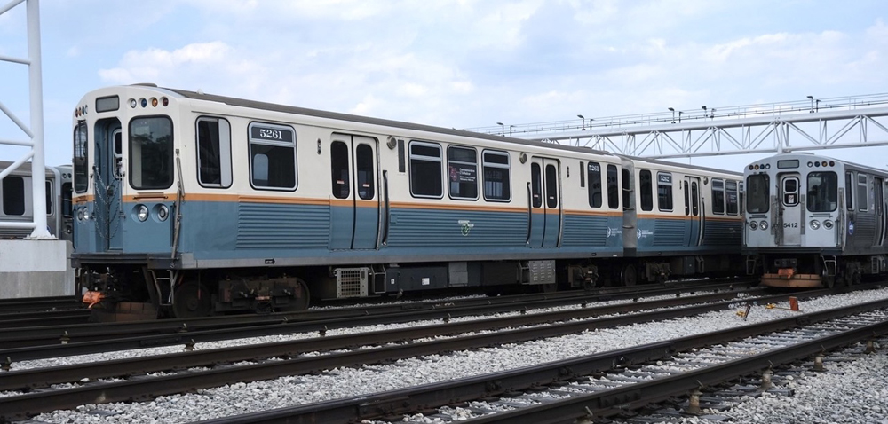 Rapid transit car with creme, green, and orange color scheme