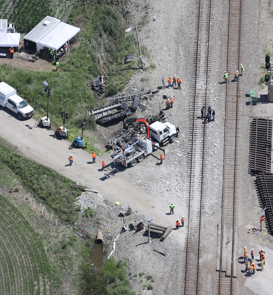 Aerial view of accident site with debris of truck hit by train