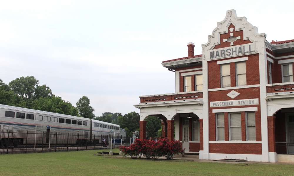 Train at ornate brick station