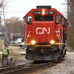Crew member on ground next to locomotive
