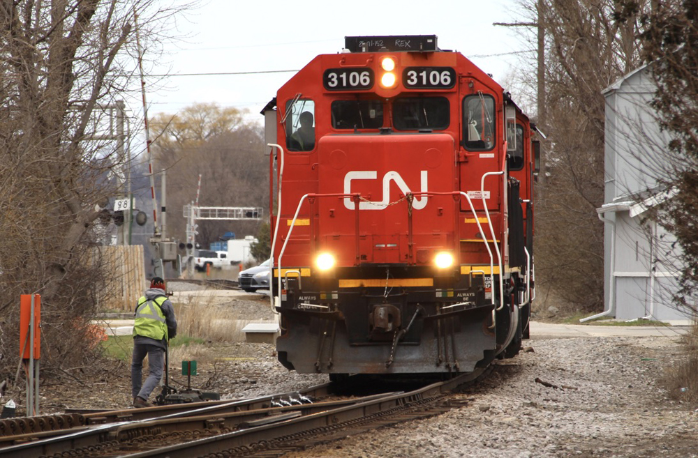 Crew member on ground next to locomotive