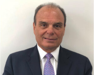 Head shot of man in coat and tie