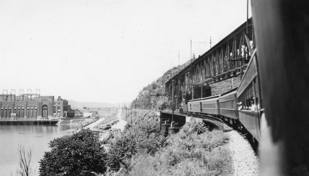 Black-and-white photo of bridge from below, from onboard train 