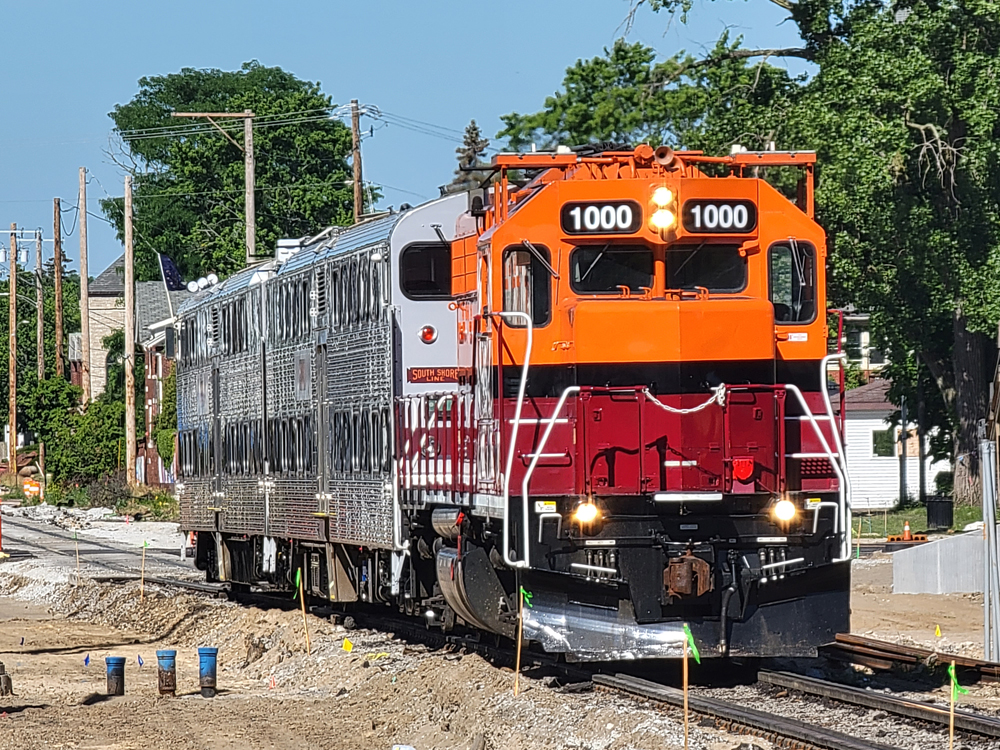 Orange and Red diesel with two passenger cars