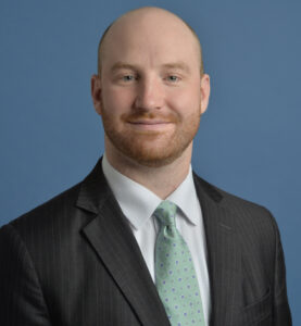 Man in dark coat and green tie