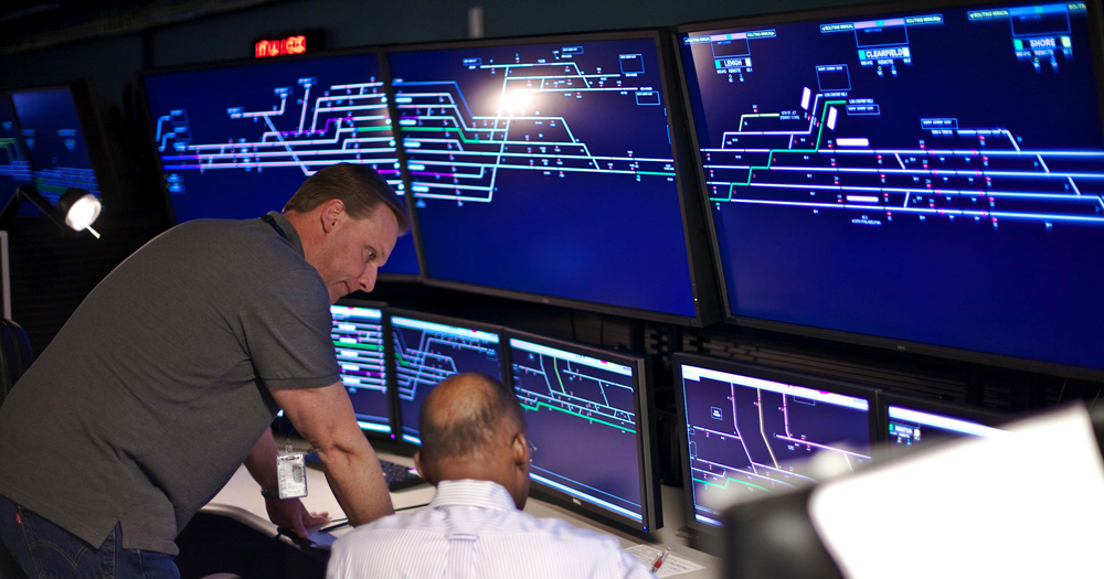 Men looking at rail dispatching displays