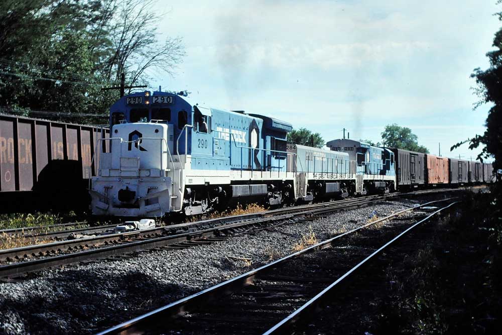 Blue and white diesel locomotives with refrigerated freight cars for Rock Island perishable traffic