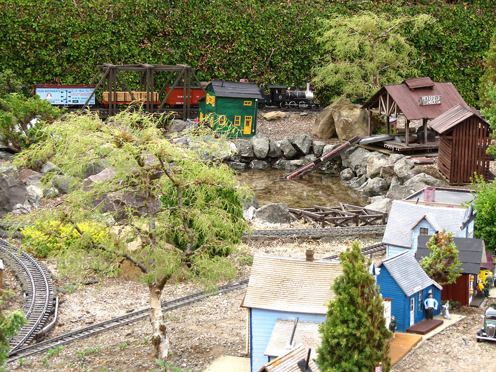 garden railway scene with train and two trees