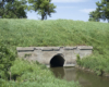 Concrete culvert with water and grass