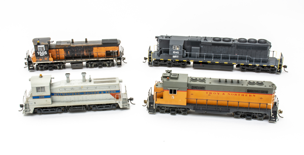 Photo of four HO scale locomotives on white background.