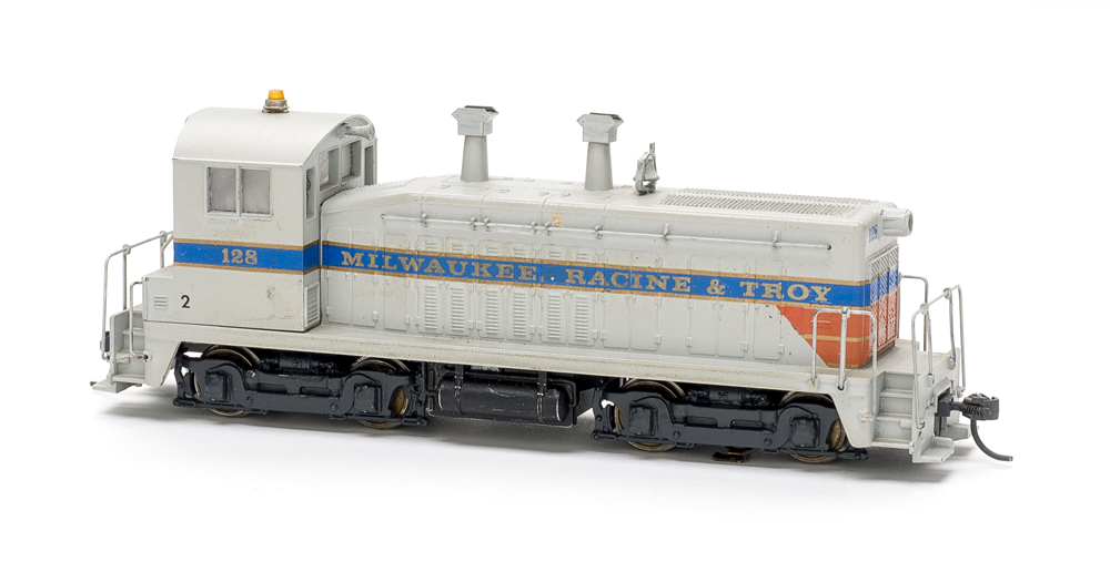 Photo of HO scale end-cab switcher on white background.