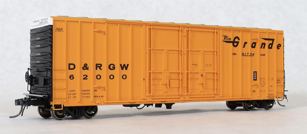 Photo of orange HO scale boxcar on white background