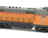 Photo of HO scale four-axle locomotive on white background.