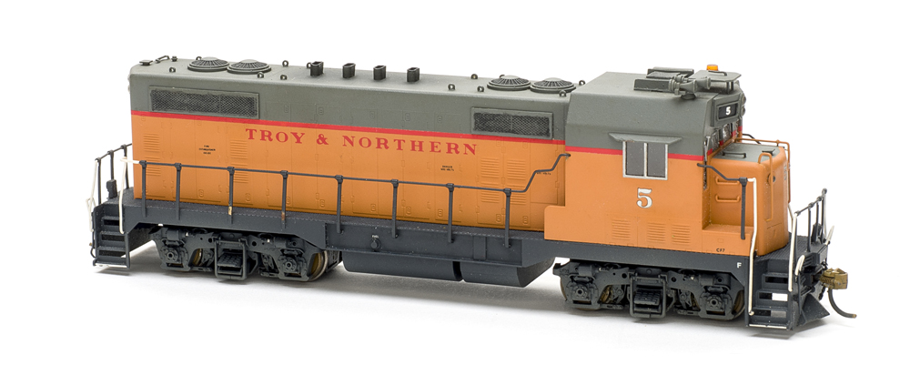 Photo of HO scale four-axle locomotive on white background.