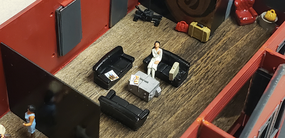 closeup of figure sitting on couch