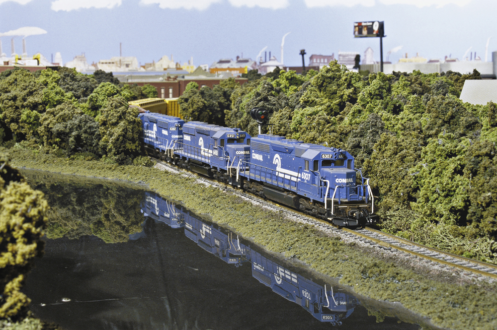 two model locomotives in a scene on a model railroad