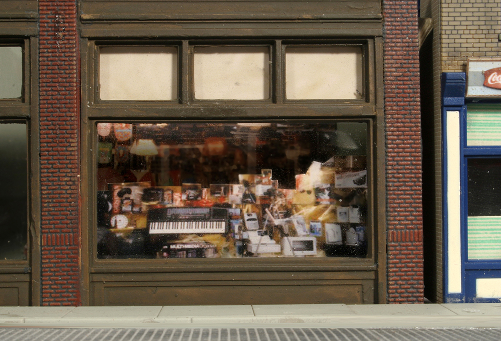 storefront window display with images in foreground and background