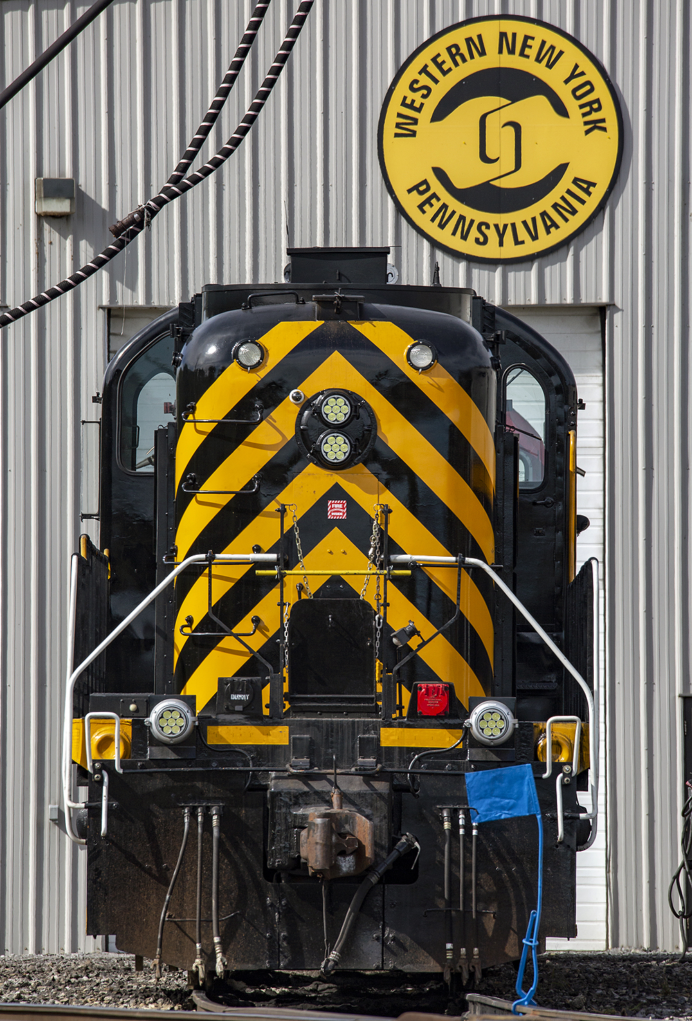 A black-and-yellow first-generation diesel locomotive in a locomotive shop.