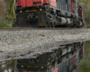 Locomotive and reflection in a puddle of water.