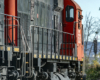 Image of parting locomotives with an engineer looking back at the photographer.